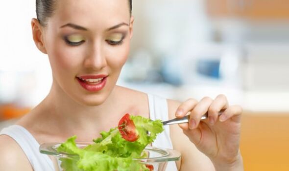 Girl eats vegetables on her favorite diet